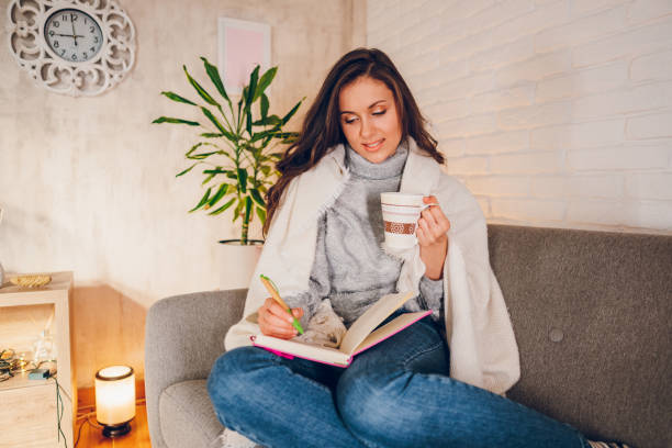 istock A woman is writing a diary at home 2058666524
