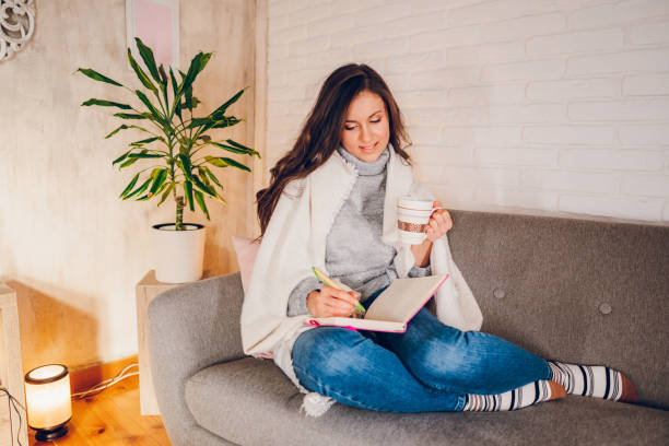 istock A woman is writing a diary at home 2058667072