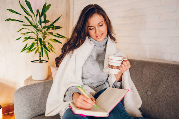 istock A woman is writing a diary at home 2058667588
