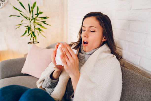 Sick woman sitting at home