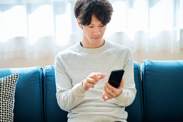 istock young man holding a smartphone 2058678890