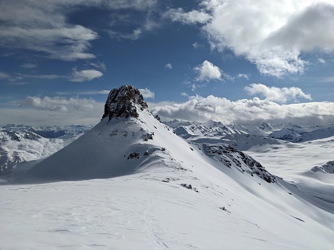 Ski tour on the Spitzmeilen and Wissmeilen in Glarnerland. Ski mountaineering in very strong winds. Skimo in winter with beautiful deep snow. Skitour Flumserberg. High quality photo.