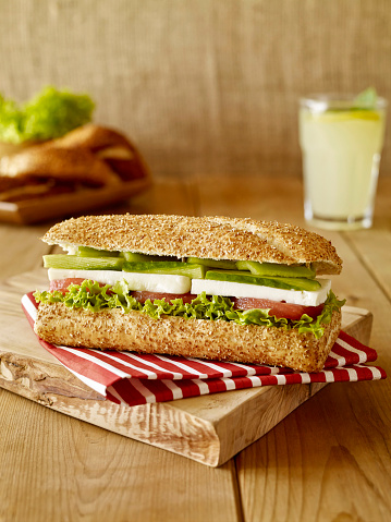Delicious vegetarian sandwich and lemonade  on wooden table