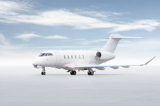 istock Modern white business jet isolated on bright background with sky 2058691783