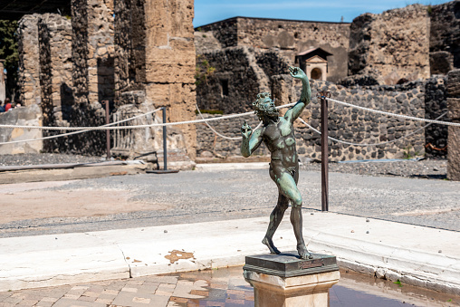 The famous dancing faun in the Pompeian house of the faun, Southern Italy