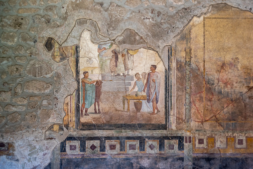 Scenic painting of Roman inhabitants in a fresco of an ancient Roman villa in Pompeii, Southern Italy