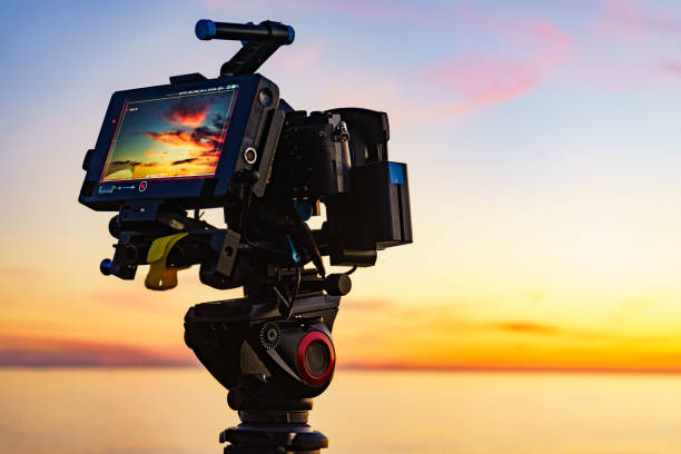istock Camera taking picture of sunset over sea 2058730076