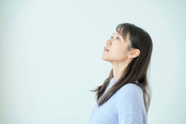istock Portrait of a young woman looking up 2058736729