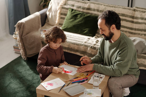 istock Boy preparing postcard for mother day 2058743816