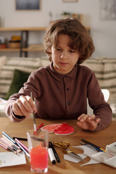 istock Creative boy painting with watercolors 2058744313