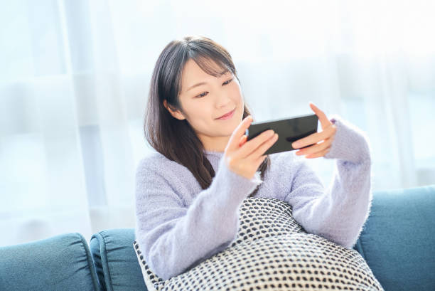 istock Young woman looking at smartphone screen 2058745454