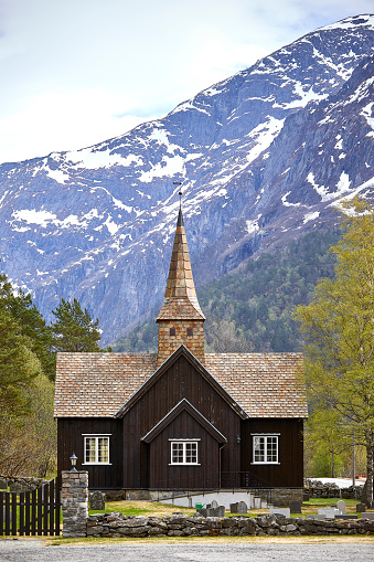Church in Norway with mountains in the back on a sunny day