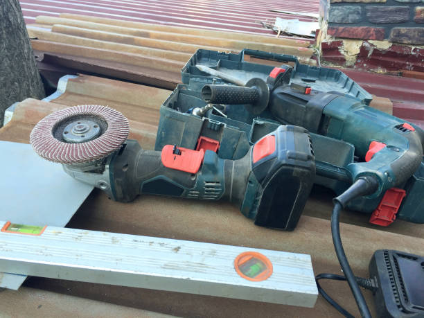 Construction work tools on the building roof. Electric work tools for roof repair