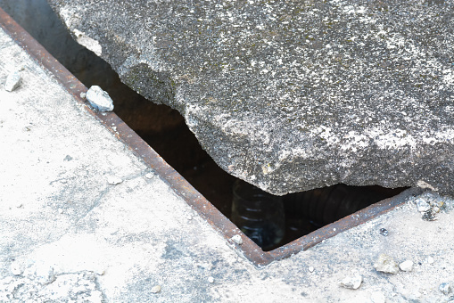 Damaged cement manhole covers and broken steel wires exposed on sidewalks and roads pose a significant danger to pedestrians and motorists alike.