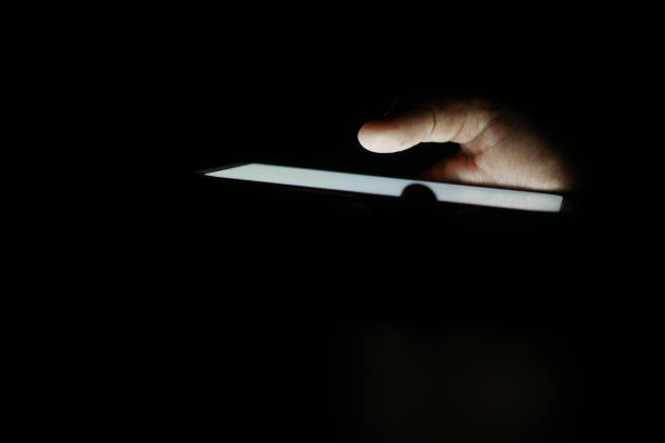 istock Close up of young man hand using smart phone at night 2058795765