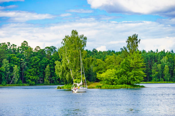 Yacht on lake in Tuchola Forests, Poland. Boat yacht on lake during summer. Tuchola national park in Poland. Yachting, holidays concept. bory tucholskie stock pictures, royalty-free photos & images
