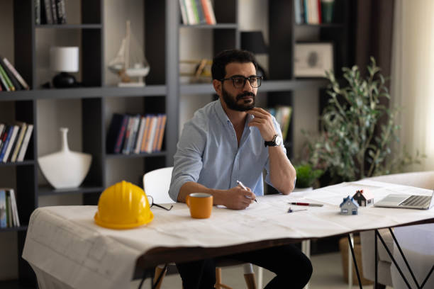 istock Architect reviewing his drawings 2058798915