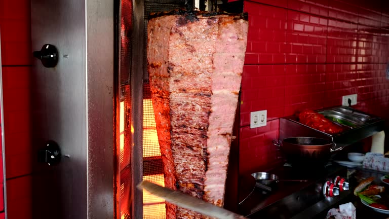 Meat doner, which is in Turkish food culture. The man cuts the doner into thin strips.