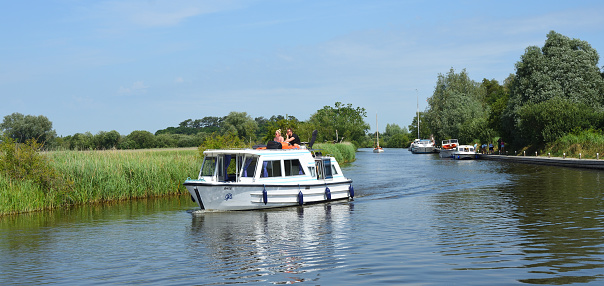 Ludham, Norfolk, England - July 08, 2023:  Broads Cruiser on the river Ant Norfolk Boards