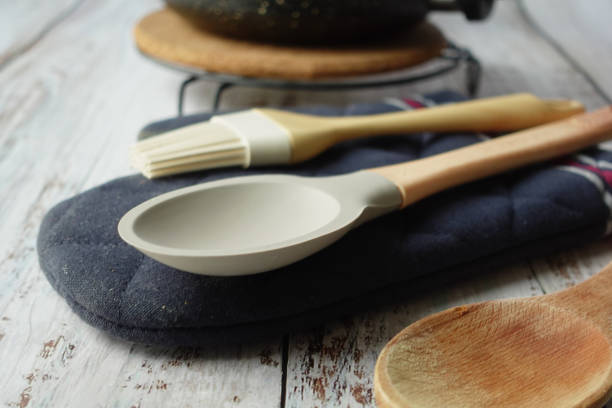istock wooden cutlery forks and cooking pan on table 2058814526