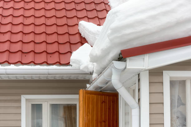 istock A large snowdrift hangs dangerously over the front door. Spring thaw. 2058830322