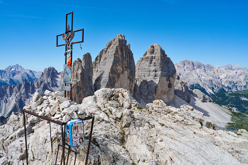 Sesto, Italy - July 09, 2022: a crucifix on the top of Paterno Mountain, locally know as Paternkofel.