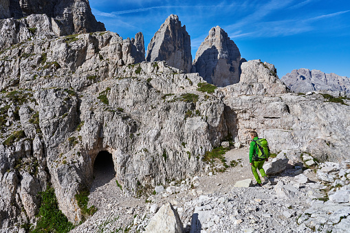 Sesto, Italy - July 08, 2022: an alpinist approach the via ferrata on Paterno Mountain, locally know as Paternkofel seen from Sexten Dolomites. Sesto Municipality. Bolzano Province. Trentino-Alto Adige. Italy.