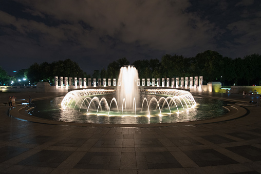 Fountain at World War II memorial at night in Washington, USA