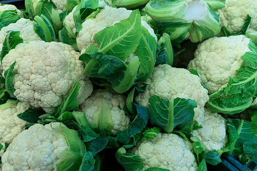 Close-up of organic cauliflower for sale at outdoor farmer's market.