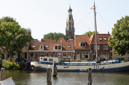 Cityscape of the picturesque town of Enkhuizen with the church tower of the Zuiderkerk in the background.