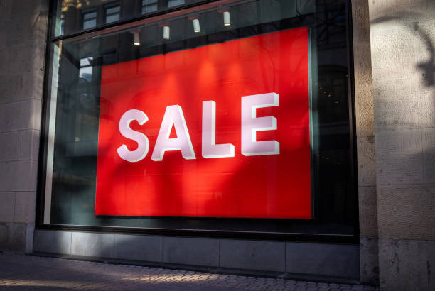 istock Eye-Catching Offer: Vibrant Red Sale Sign in a Storefront Window, Attracting Shoppers 2058863247