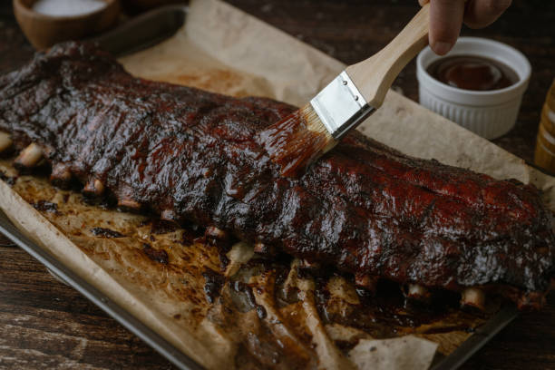 istock applying bbq sauce on pork spare ribs with brush 2058871658