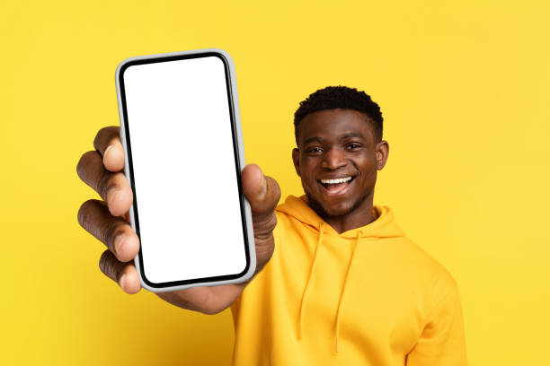 istock Happy young black guy showing big phone with blank screen 2058883827