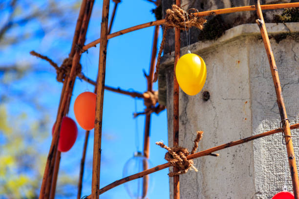 Colorful painted decorative Easter eggs hanging by an iron frame outside