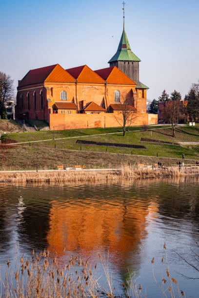 istock Ancient medieval village church reflected in the river water 2058928383