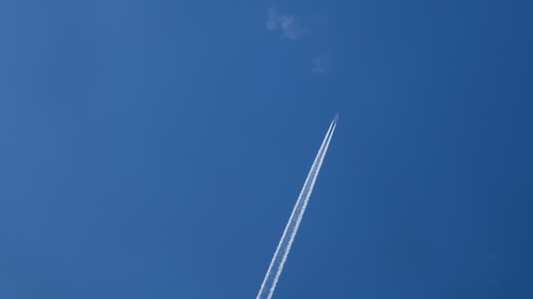 Airplane flying on deep cloudy blue sky