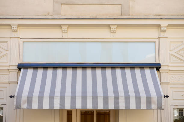 istock Gray and white awning over the windows on the white wall 2058942776