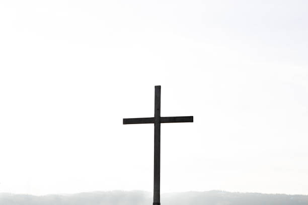 Religion theme, view of catholic cross silhouette, on white background. Copy space