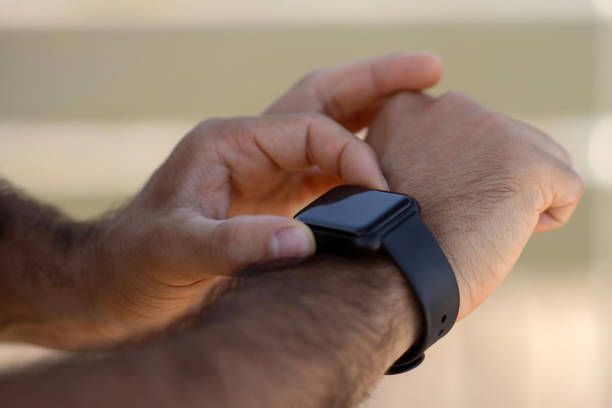 istock Closeup of male hands using fitness tracker during outside training 2059032422