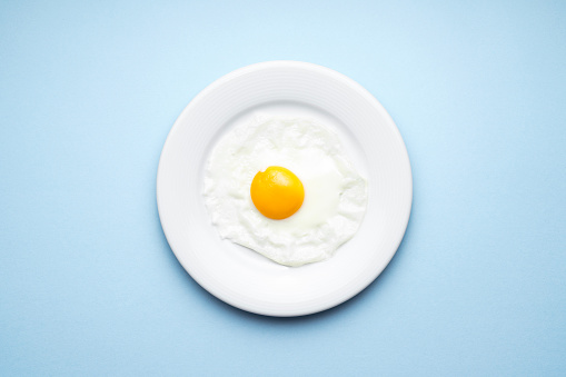 Plate of egg on a blue background