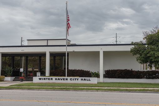 Winter Haven, FL, USA, 3-4-24. Wide angle view of administration city hall building with overcast skies in background