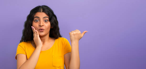 istock Amazed young indian woman pointing at copy space 2059046981
