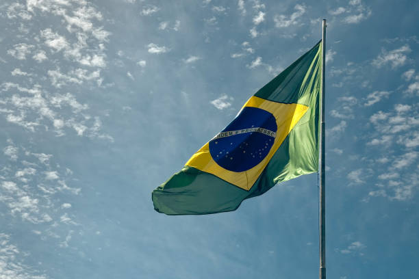 istock Brazilian waving flag in a blue sky 2059049683