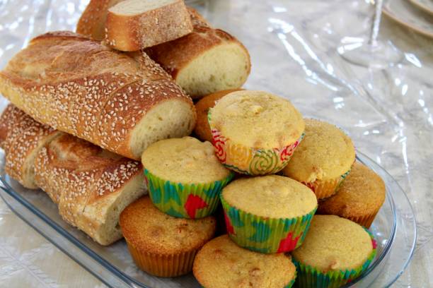 Bread Basket A bread tray fill with Italian bread and corn muffins. bread bun corn bread basket stock pictures, royalty-free photos & images