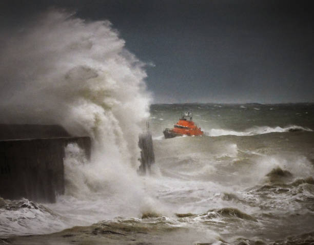 Lifeboat RNLI Lifeboat returns to harbor in a raging storm off the Sussex coast , UK lifeboat stock pictures, royalty-free photos & images