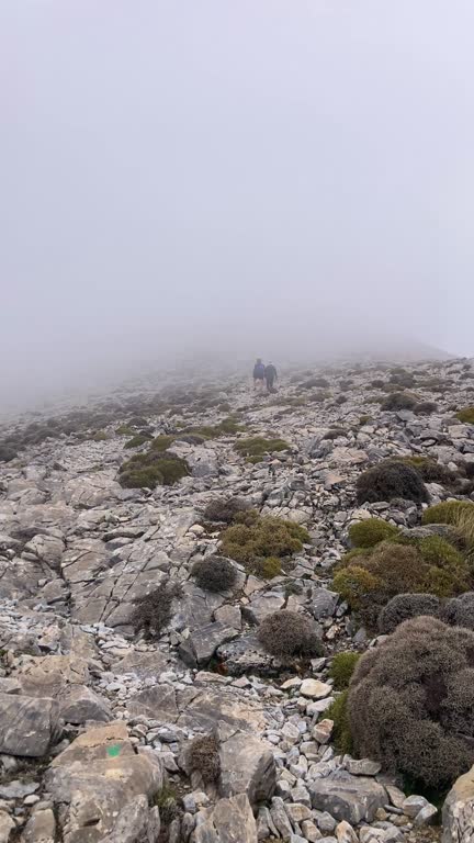 Fog and clouds on hiking trail to Maroma peak in thunderstorm day