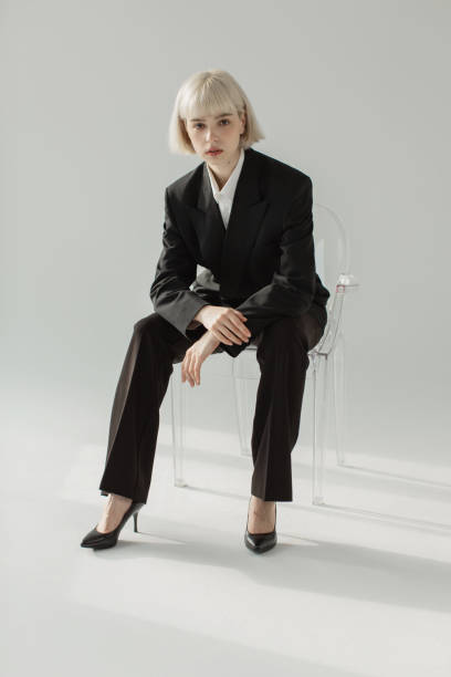 Blonde woman in black suit in studio. Fashion model. Blonde woman in black suit supermodel pose stock pictures, royalty-free photos & images