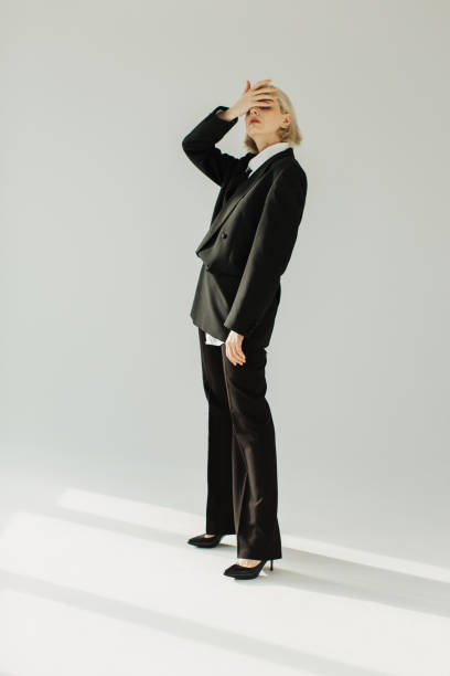 blonde woman in black suit in studio. fashion model. - fashion fashion model asian ethnicity tall imagens e fotografias de stock