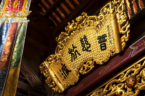 Golden panel with Vietnamese inscription at Thien Tru Temple, Perfume Pagoda, Vietnam