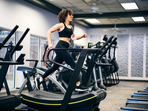 istock Athletic Woman Running on a Treadmill in a Gym 2059206427